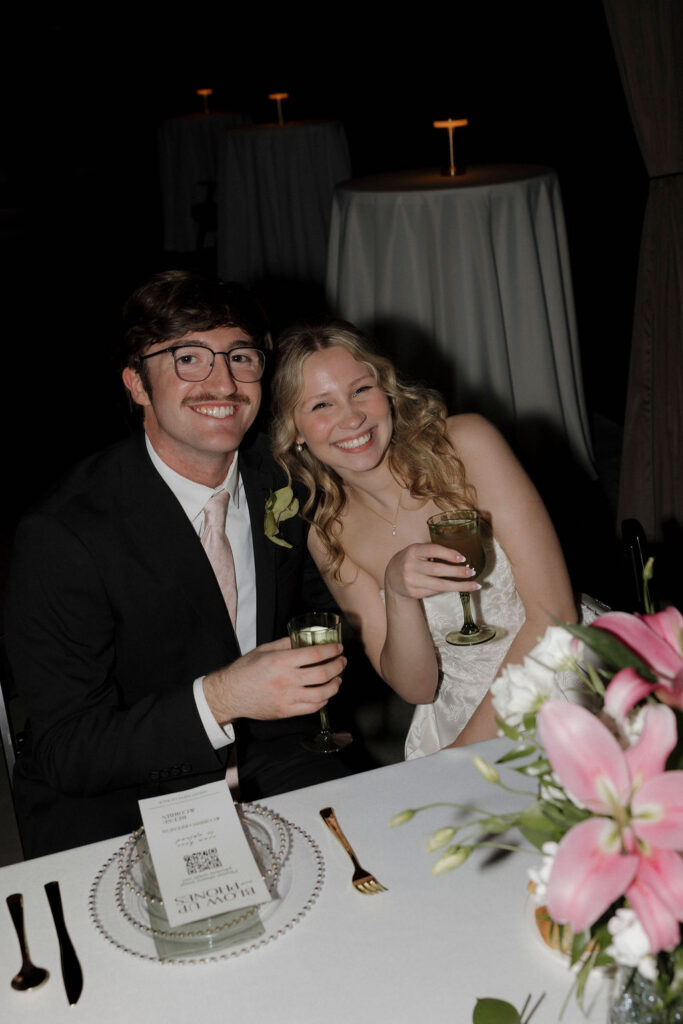 Bride and groom smiling candidly at their reception at Bespoke in Bond in Bardstown, Ky.