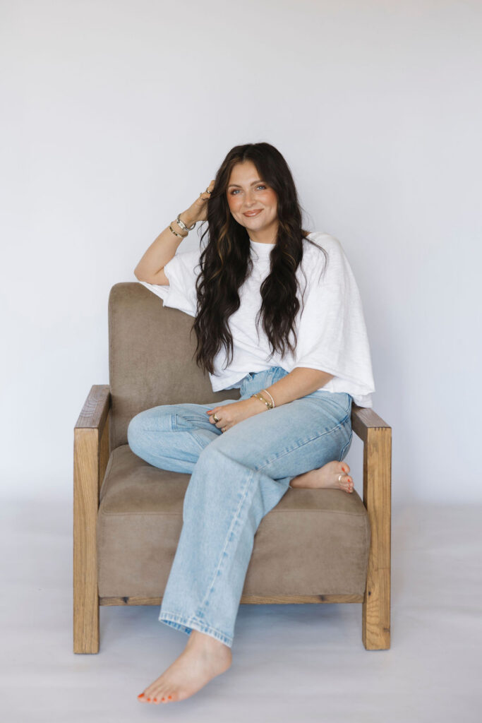 Louisville branding photographer | an esthetician casually sitting in a chair with a welcoming smile.