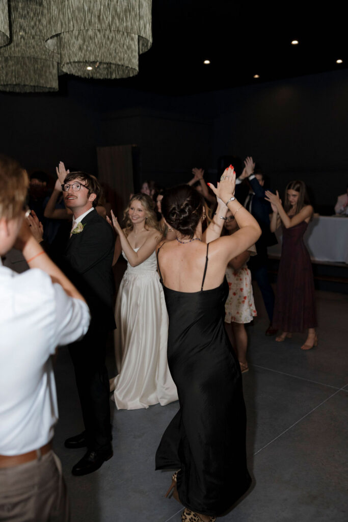 Guests dancing with the bride and groom at the reception of their wedding at Bespoke in Bond in Bardstown, Kentucky.