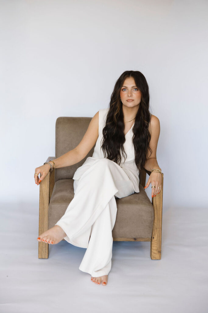 Louisville branding photographer | an esthetician sitting in a chair with a serious face.