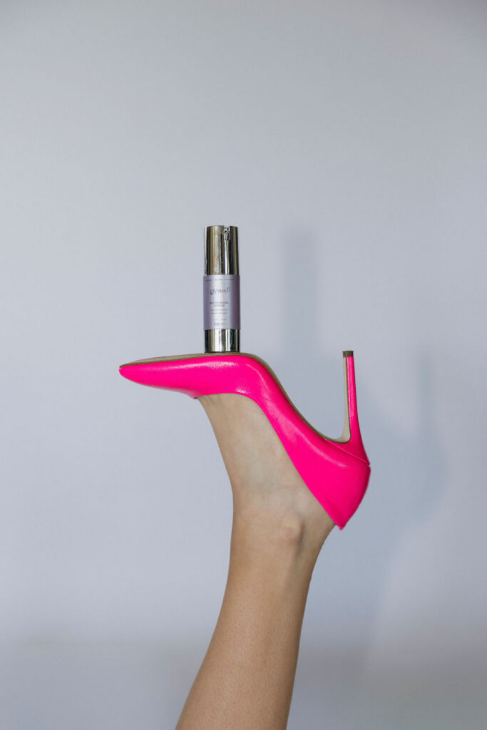 Louisville branding photographer | a foot in a hot pink shoe with a facial product balancing on the bottom of the shoe.