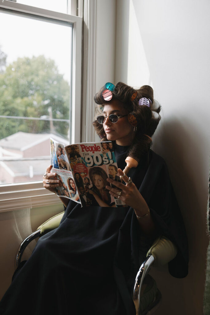 Louisville hairstylist reading a magazine during a retro branding session.
