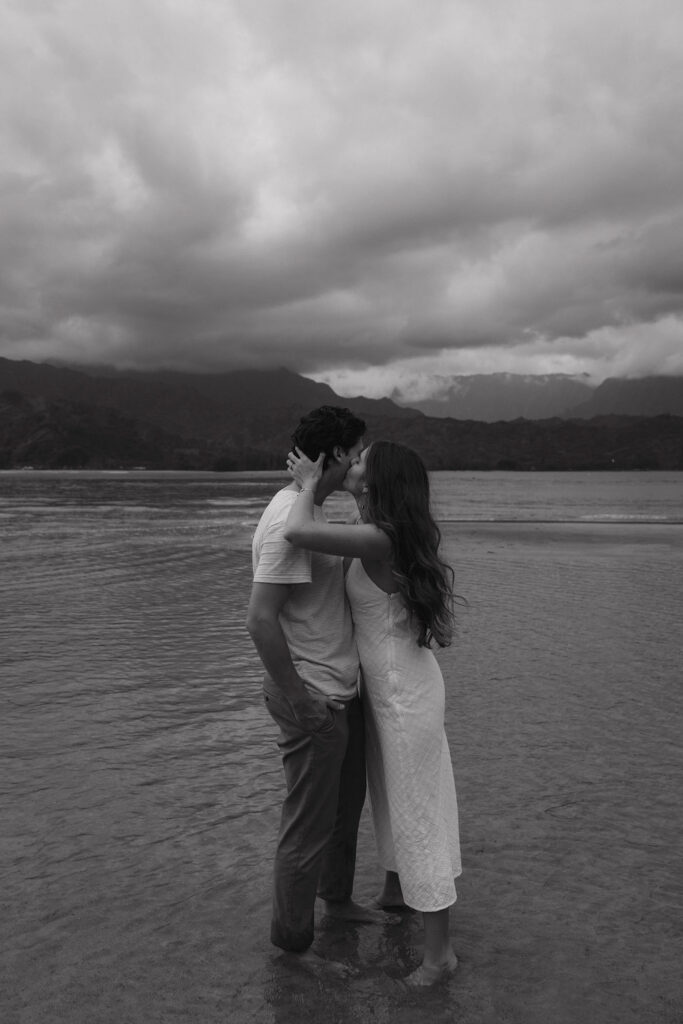 Cinematic beach engagement photos captured on the island of Kauai