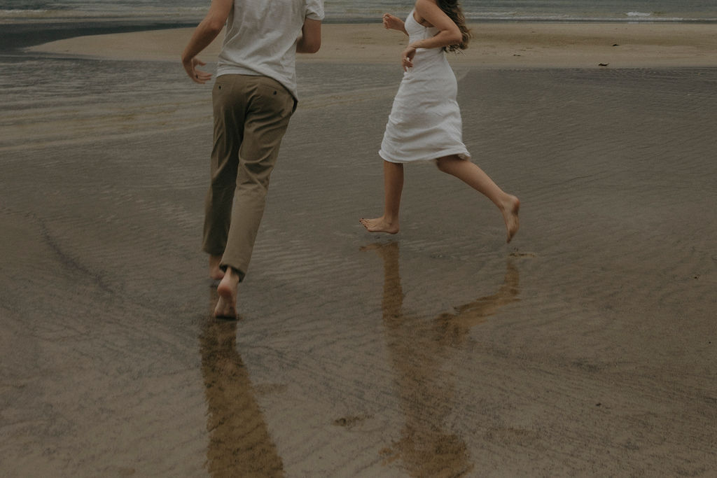Couple having fun during their Hanalei Bay engagement photos
