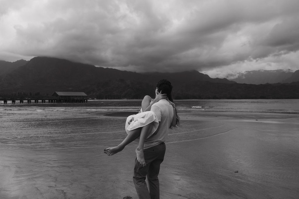 Documentary-style engagement photograph captured on the coast of Kauai