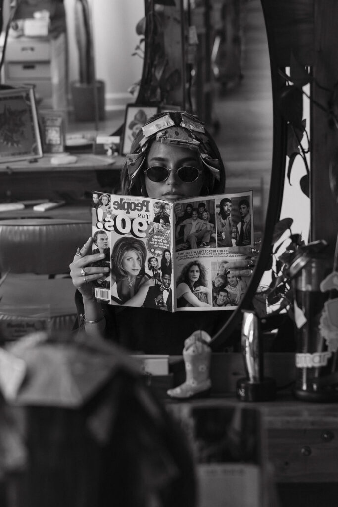 Client of Avery at Atomic House of Hair in Louisville processing while reading a magazine.