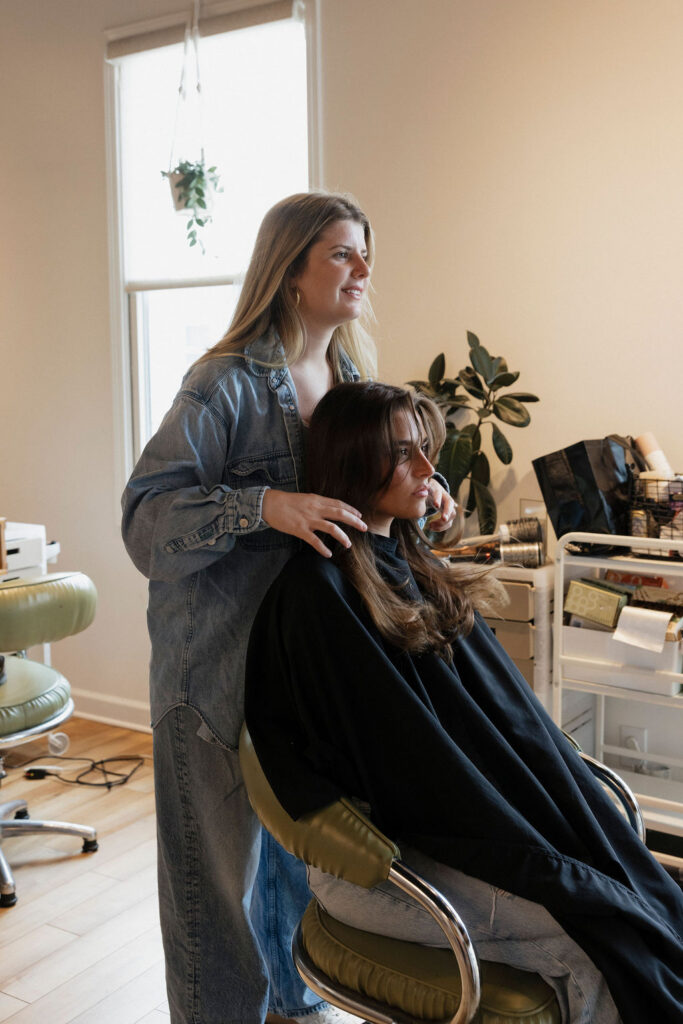 Louisville hairstylist working with a client inside Atomic House of Hair.