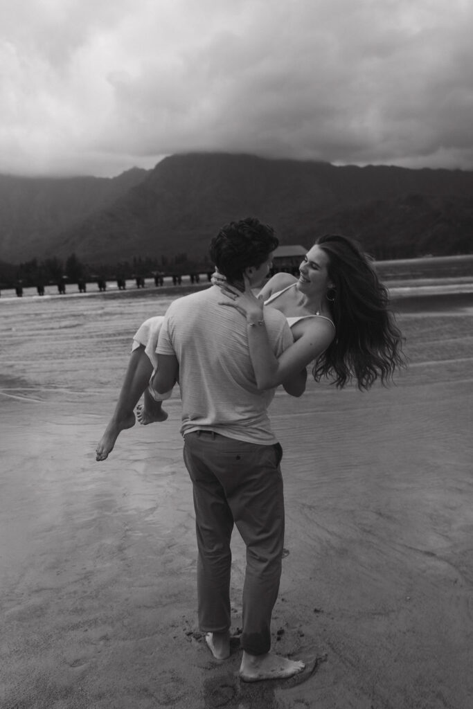 Moody beach engagement portraits in Kauai, Hawaii