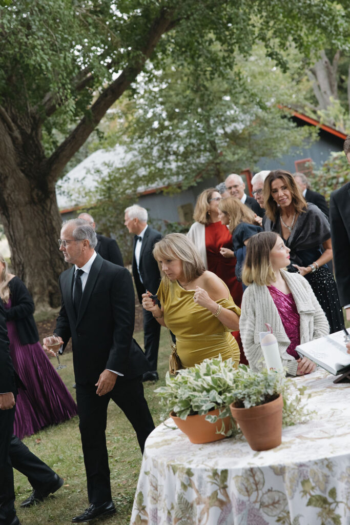 Guests at cocktail hour moving their way into the tented reception area.
