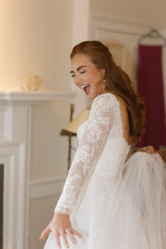 The bride showing a face of excitement as she's finished getting ready for the big day.